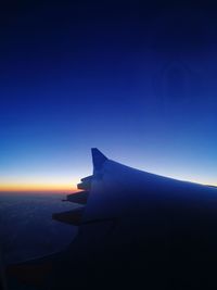 Airplane wing against clear sky