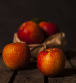 Close-up of apples on table against black background