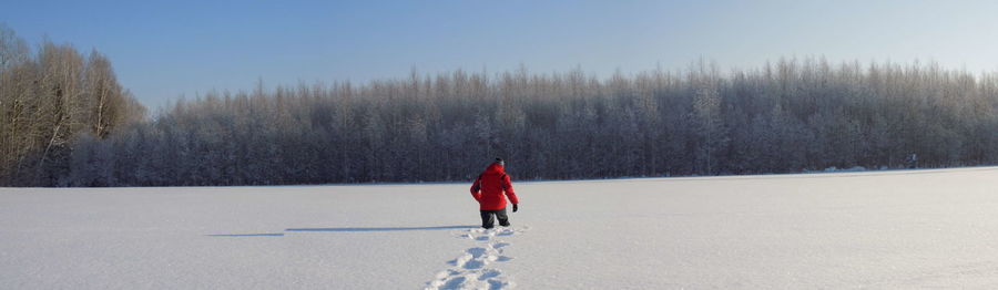 Person walking on snow covered field