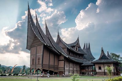 Low angle view of temple against cloudy sky