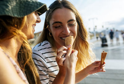 Portrait of smiling young woman holding ice cream