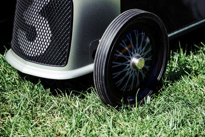 Close-up of black car on field