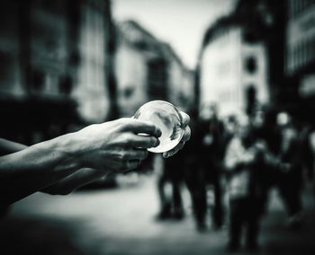 Close-up of hands holding transparent ball