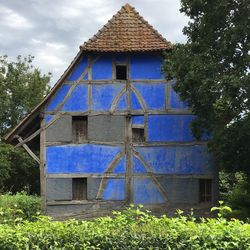 Exterior of house on field against sky