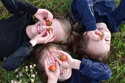 Close-up of children lying on grass