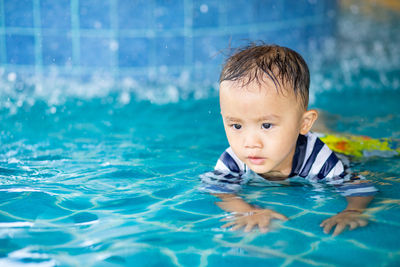 Portrait of boy swimming in pool