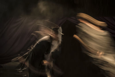 Blurred motion of woman at music concert