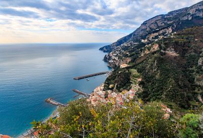 Scenic view of sea and mountains against sky