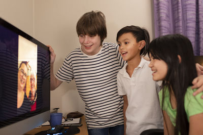 Children talking via vide chat with grandmother