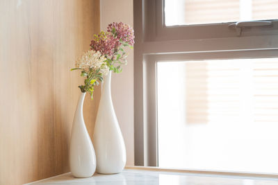 Close-up of flower vase on table at home