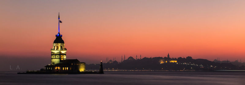 Illuminated maiden tower at bosphorus during sunset