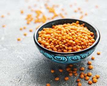 Organic healthy red lentils in bowl on a table