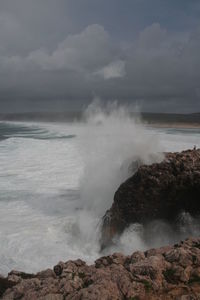 Waves breaking against rocks
