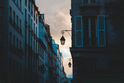 Low angle view of street light against building