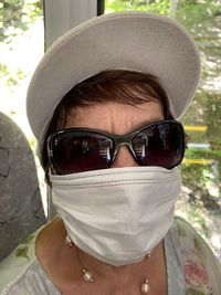 Close-up portrait of a young woman wearing sunglasses