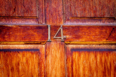 House number 14 on a varnished wooden front door in london 