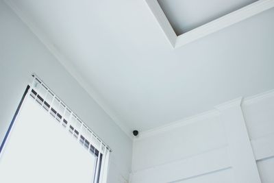 Low angle view of security camera on ceiling