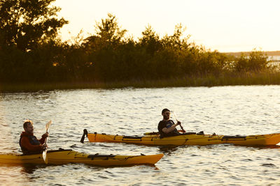 Men kayaking on sunny autumn day