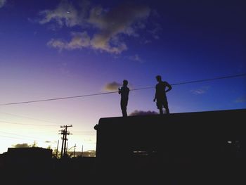 Low angle view of silhouette people at sunset