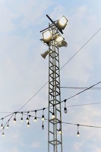Low angle view of illuminated floodlight against sky
