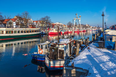 Boats moored at harbor