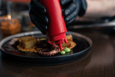 Midsection of man preparing food on table