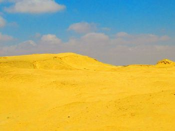 Scenic view of yellow desert against sky