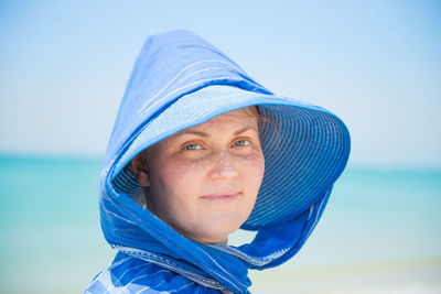 Portrait of mid adult man against blue sea