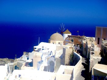 High angle view of buildings against blue sky