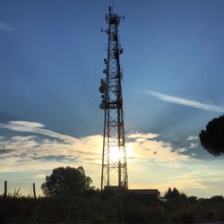 Low angle view of communications tower against sky