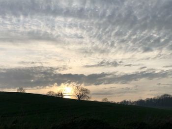 Scenic view of field against sky during sunset