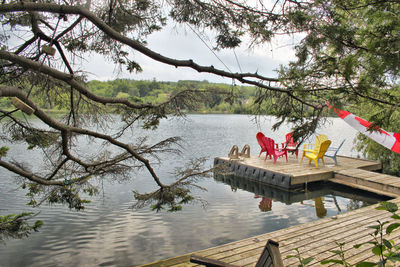 Chairs by lake on jetty