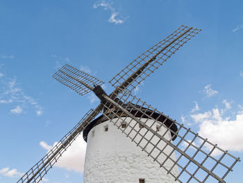 Low angle view of traditional windmill against sky