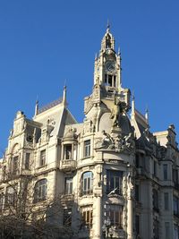 Low angle view of building against clear blue sky