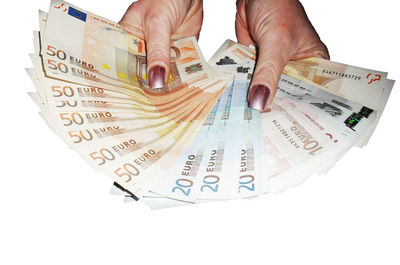 Close-up of hand holding text against white background
