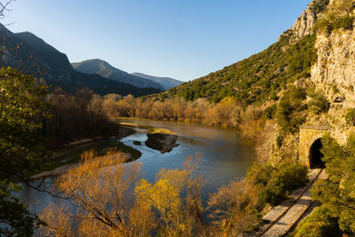 Scenic view of lake and mountains against clear sky