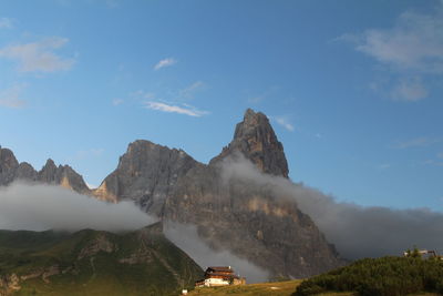 Scenic view of land and mountains against sky