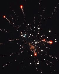 Low angle view of firework display at night