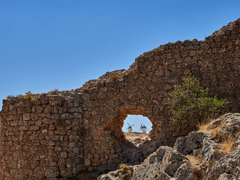 Windmills and castle in the background of the town of consuegra, spain