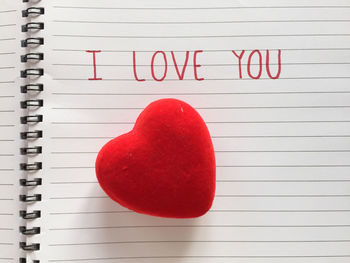 Close-up of red heart shape on book