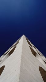 Low angle view of building against clear blue sky