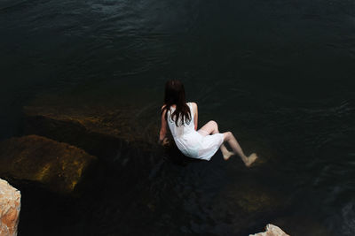 Woman sitting in water