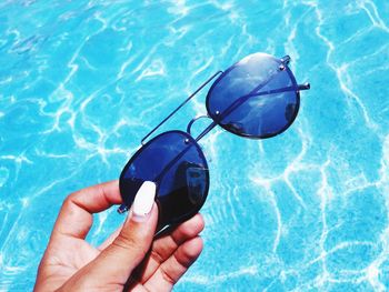 Close-up of hand holding swimming pool