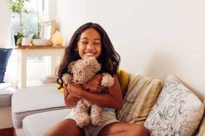 Portrait of young woman with teddy bear