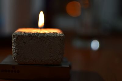 Close-up of lit candles on table