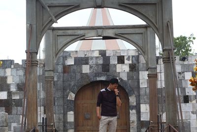 Man standing at historical building