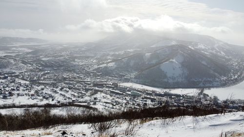 Aerial view of snowcapped mountains against sky