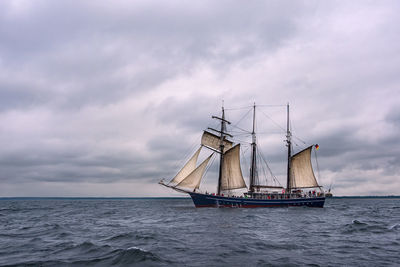 Sailboat sailing on sea against sky