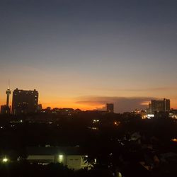 High angle view of illuminated buildings against sky at sunset