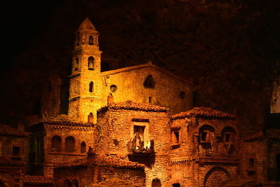 Low angle view of illuminated cathedral against sky at night